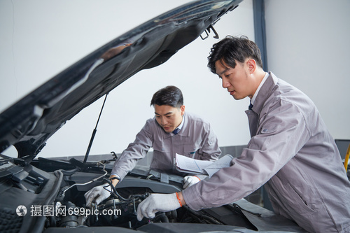 汽車修理工在檢查發(fā)動機兩人檢查汽車